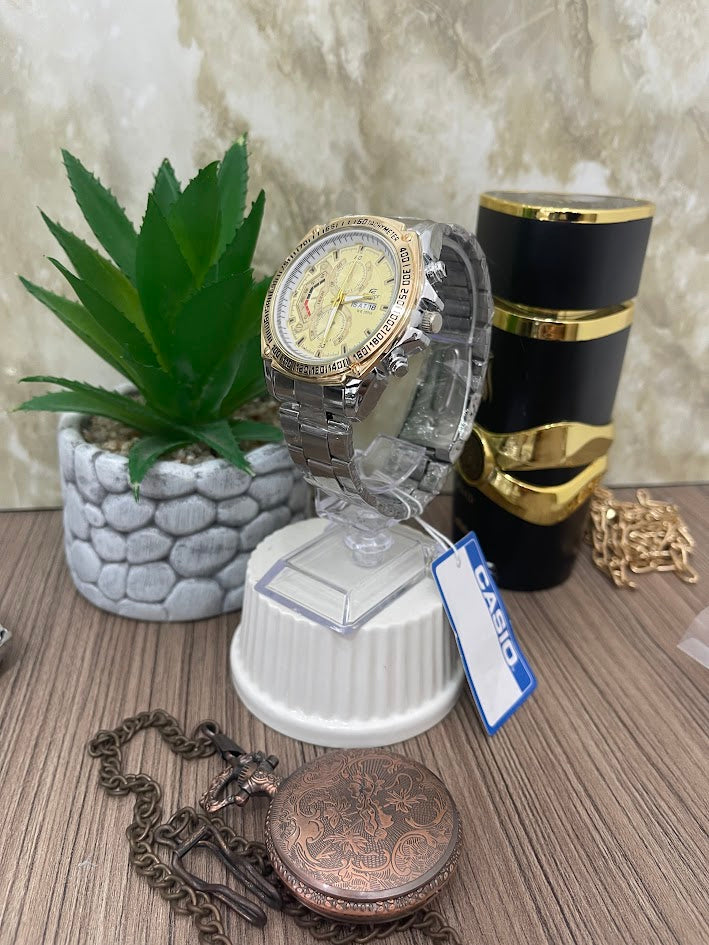 CASIO HOMBRE PLATEADO ESFERA DORADA ARO DORADO