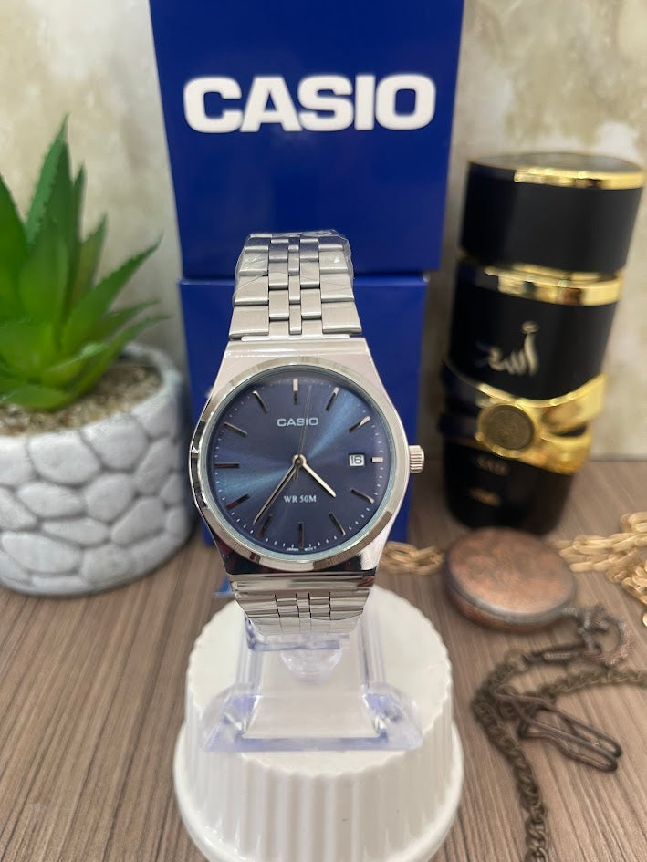 CASIO DAMA PLATEADO MANILLA TRENZADA ESFERA AZUL CALENDARIO