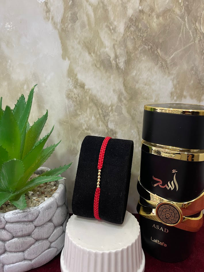 PULSERA ROJA TEJIDA BALINES X 6