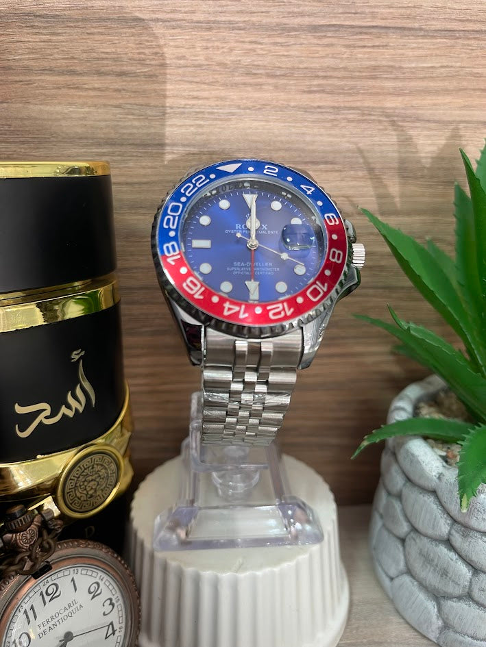 RELOJ ROLEX CABALLERO PLATEADO DETALLES AZUL Y ROJOS