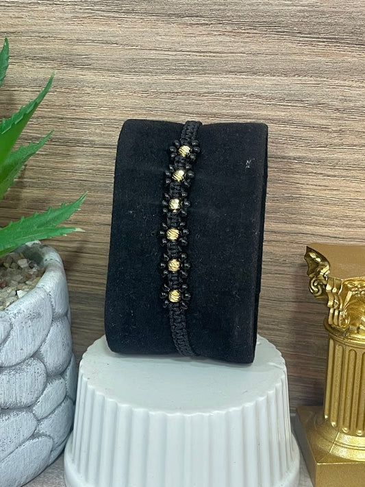 PULSO EN ORO LAMINADO FLORES NEGRO