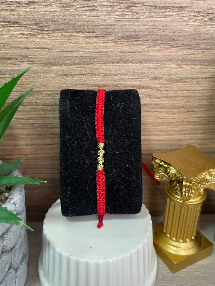PULSERA TEJIDA ROJA 4 BALINES ORO LAMINADO