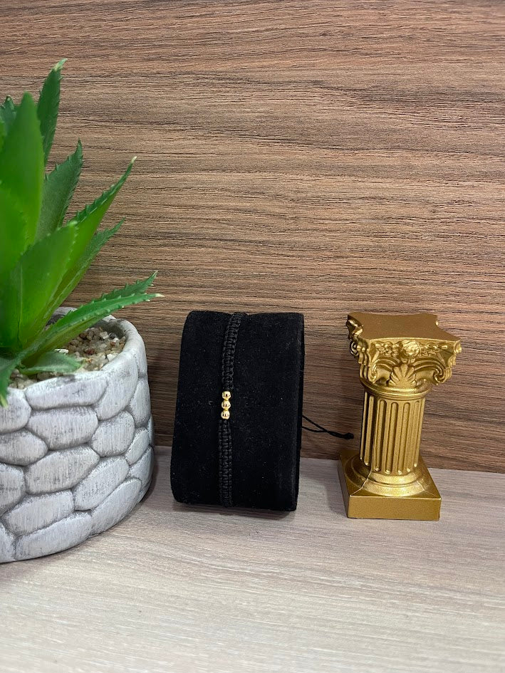 PULSERA TEJIDA NEGRA BALIN X3 ORO LAMINADO