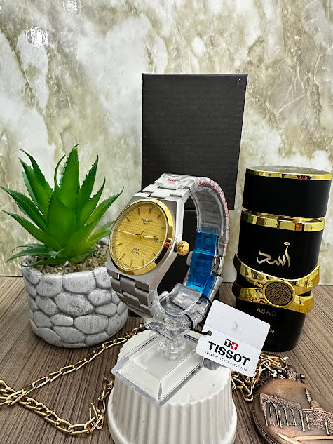 RELOJ TISSOT PLATEADO ESFERA DORADA ARO DORADO