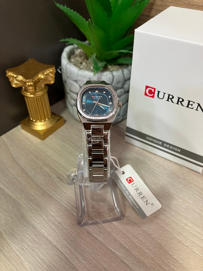 RELOJ CURREN DAMA CUADRADO PLATEADO FONDO AZUL