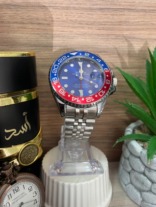 RELOJ ROLEX CABALLERO PLATEADO DETALLES AZUL Y ROJOS